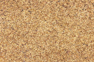 Natural cork texture with a brown grain pattern. Organic material closeup showing textured details. Macro view of corkboard surface ideal for backgrounds or natural design concepts.