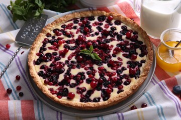Delicious currant pie and fresh berries on kitchen towel