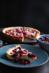 Piece of delicious currant pie and fresh berries on grey table, space for text
