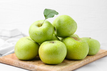 Fresh ripe green apples on white table, closeup