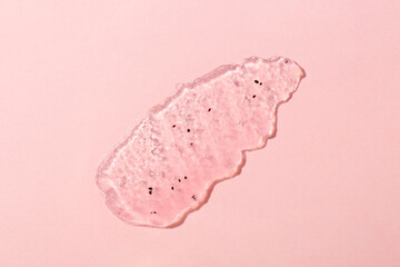 Smear of body scrub on light pink background, top view