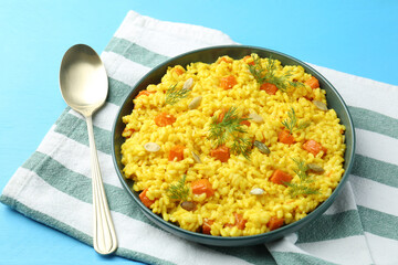 Delicious pumpkin risotto served on light blue table