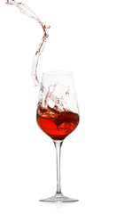 Rose wine splashing in glass on white background