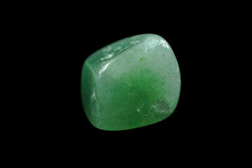 Image of aventurine with a shiny texture and a green hue, decorated with natural inclusions and light.