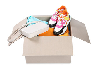 Different used clothes, bag and shoes in box isolated on white