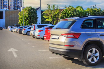 Cars in a parking lot near a shopping mall