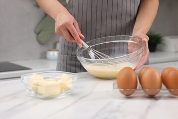Woman making dough at white marble table indoors, closeup