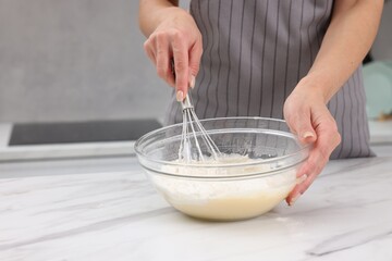 Woman making dough at white marble table indoors, closeup