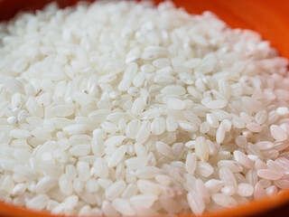 A close-up of round-grain rice, showing its shiny texture and natural hue, perfect for a culinary theme.