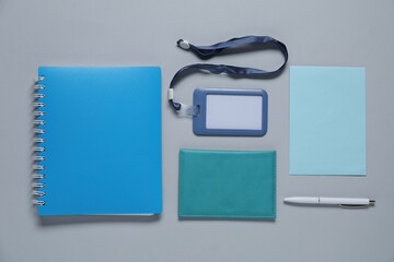 Different blank items for branding on gray background, flat lay. Mockup for design