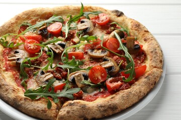 Tasty pizza with mushrooms, tomatoes and arugula on white wooden table, closeup