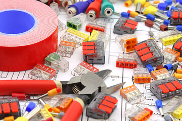 Tools and materials for assembling an electrical switchboard in the workplace.