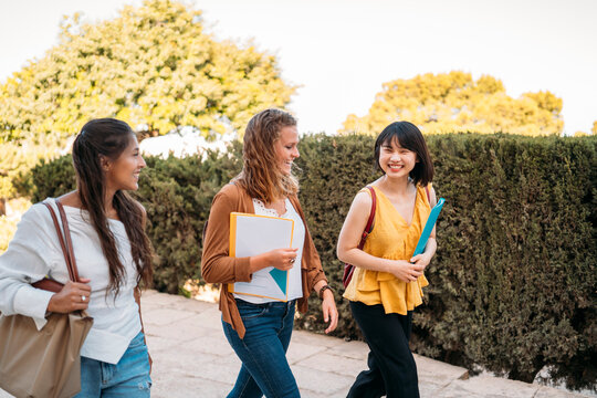 University exchange students walking and talking on campus