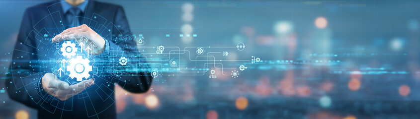 Businessman holding automation tools, technologies, systems, software, processes, devices,...