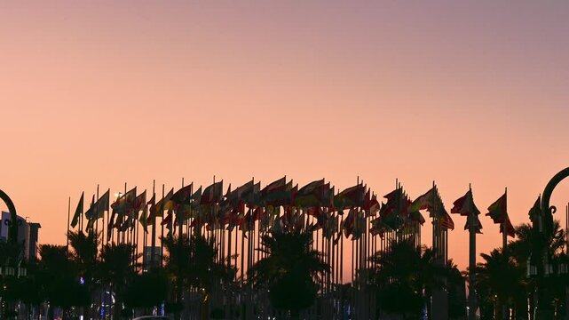 image of national flags waving at sunset in doha qatar