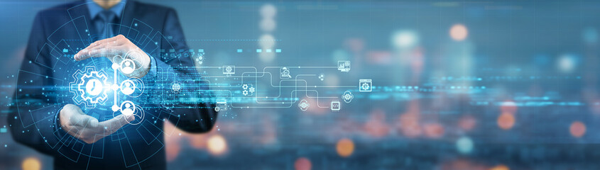 Businessman holding enterprise resource planning (ERP) software system, business intelligence tools, data analytics dashboard, real-time reporting capabilities and automation solutions.