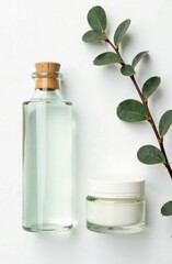 Banner with space for an inscription. Top view of glass jars with cosmetics on a white background with eucalyptus branches.