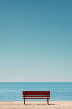 a lonely park bench on the sandy beach