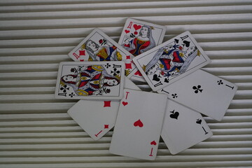 Playing cards scattered creatively on a textured surface, showcasing vibrant designs and intriguing compositions of suits and faces