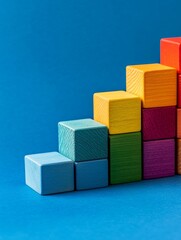 Naklejka premium Colorful Wooden Blocks Staircase - Colorful wooden blocks arranged in ascending order, symbolizing growth, progress, success, development, and achievement.