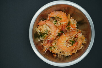 Delicious shrimp fried rice garnished with fresh herbs in a silver bowl ready to be enjoyed