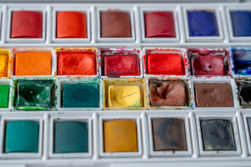 Paris, France - 01 12 2025: Top view of a Watercolor paint box with colorful watercolor buckets.