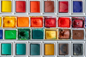 Paris, France - 01 12 2025: Top view of a Watercolor paint box with colorful watercolor buckets.