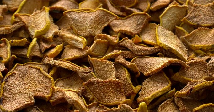 Dried quince slices background texture. Table spin. 