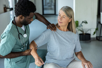 Doctor helping patient with physical therapy for injured shoulder recovery and pain relief
