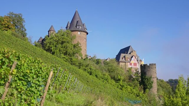 The Medieval Stahleck Castle and vineyard landscape in the upper middle Rhine River near Bacharach, Germany on a warm sunny day