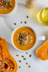 Traditional autumn butternut squash soup with seeds.