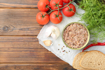 Canned meat in tin can served on wooden table, flat lay. Space for text
