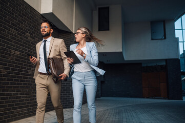Business people running late for important meeting in the city