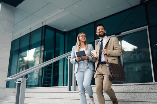 Business people walking and talking outside office building