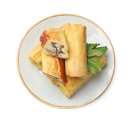 Delicious rolled crepes with mushrooms and parsley isolated on white, top view