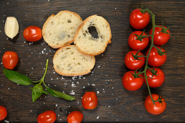 Slices of fresh bread with butter resting on a dark wooden board.