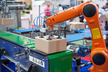 Robotic or robot arm in automated factory packing system for efficient industrial box handling and logistics