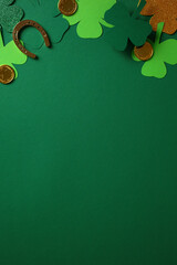St. Patrick's Day vertical background with green and glittery shamrocks, gold coins, and a...