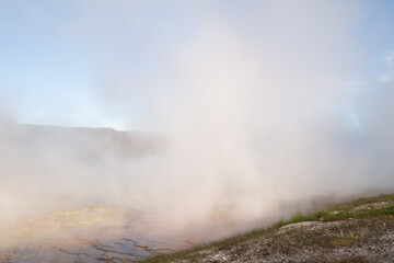 Steam rises off the hot sulphuric waters of the grand Prismatic springs of Yellowstone
