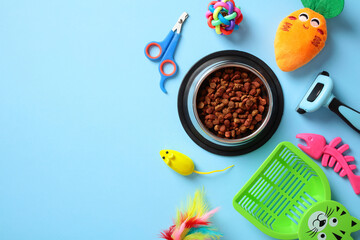 Pet care essentials on a blue background: food bowl with kibble, grooming tools, colorful toys, and...