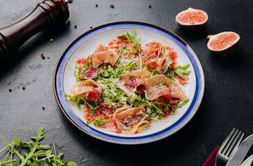Gourmet salad with prosciutto, arugula, figs, and parmesan, a perfect fusion of flavors