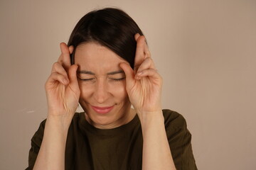 Close-up portrait of a beautiful woman crossing her fingers, hoping, asking better isolated on a...