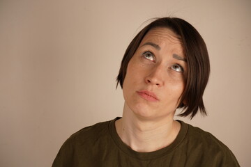 Sad bored asian female student attending boring uninteresting lecture thin face looking indifferent expressing apathy dislike grimacing and sulking frustrated standing on background.