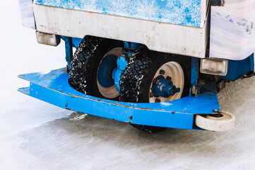 Snow machine elements with wheels in snow on ice rink for cleaning. Photo, transport.