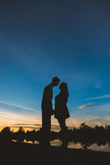 Fototapeta premium Couple in love on the background of the setting sun