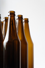 A close-up of several brown glass beer bottles neatly arranged in a group, featuring a smooth...