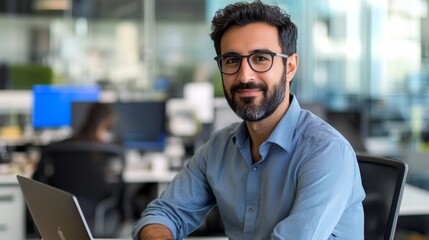 Obraz premium Confident Young Professional Working on Laptop in Busy Modern Office, 35mm Cinematic Look