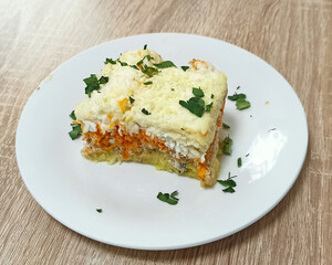 Delicious layered vegetable dish served on a white plate with garnishing