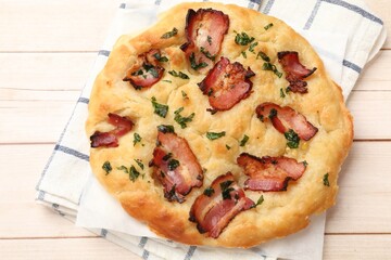 Delicious focaccia bread with bacon and parsley on white wooden table, top view