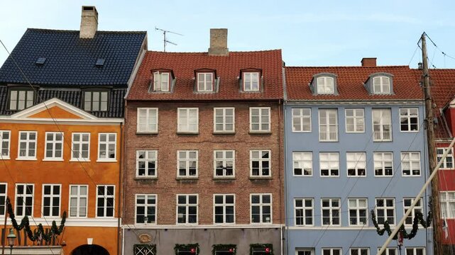 Three colorful Scandinavian houses with large windows. Architecture in the capital. Capital of Denmark
